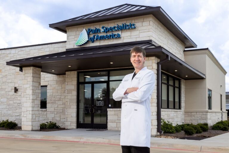 Dr. Bennjamin Fronk standing in front of the Pain Specialists of America clinic in Temple.